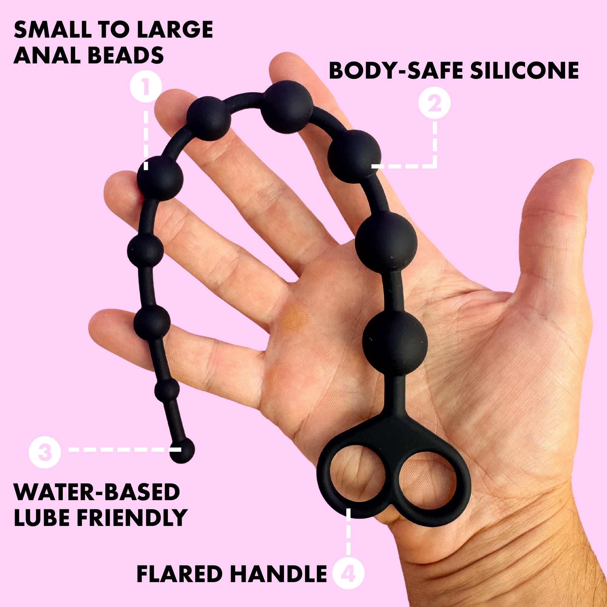 Black silicone anal beads held in a hand with product features highlighted on a pink background